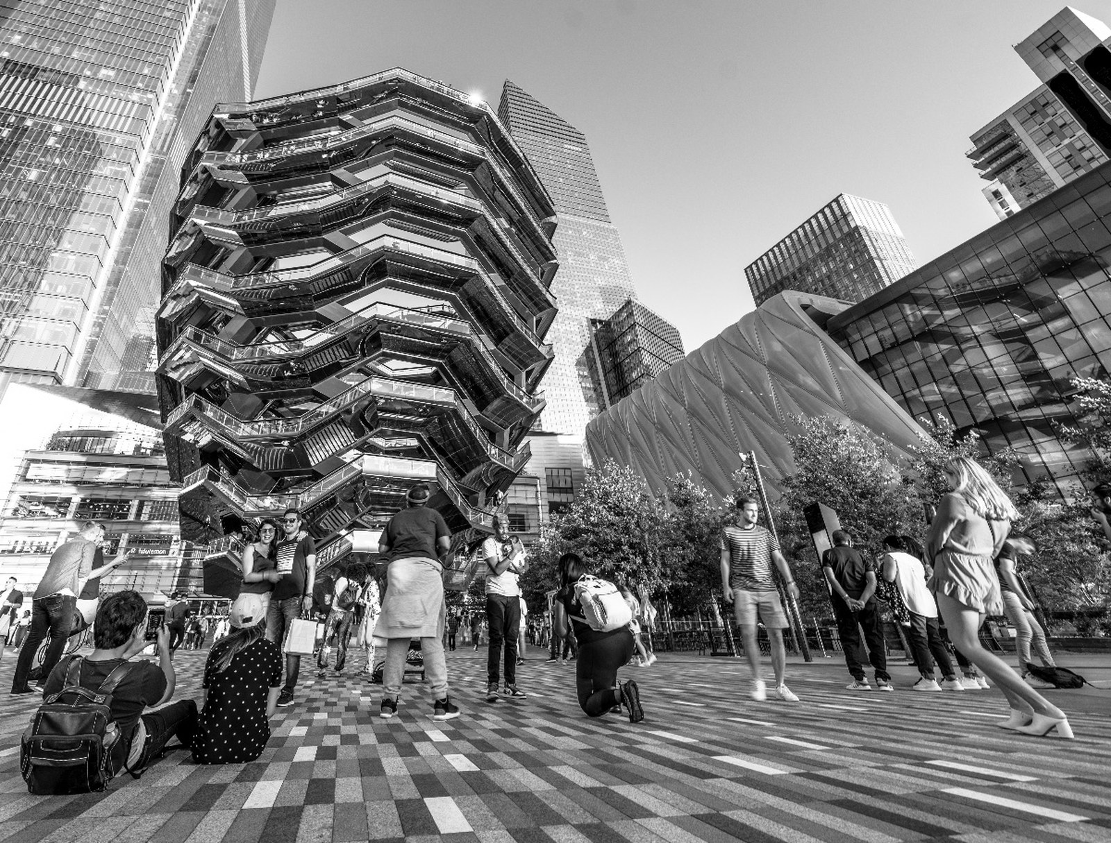 The Vessel at Hudson Yards rising over a crowd, in black and white.