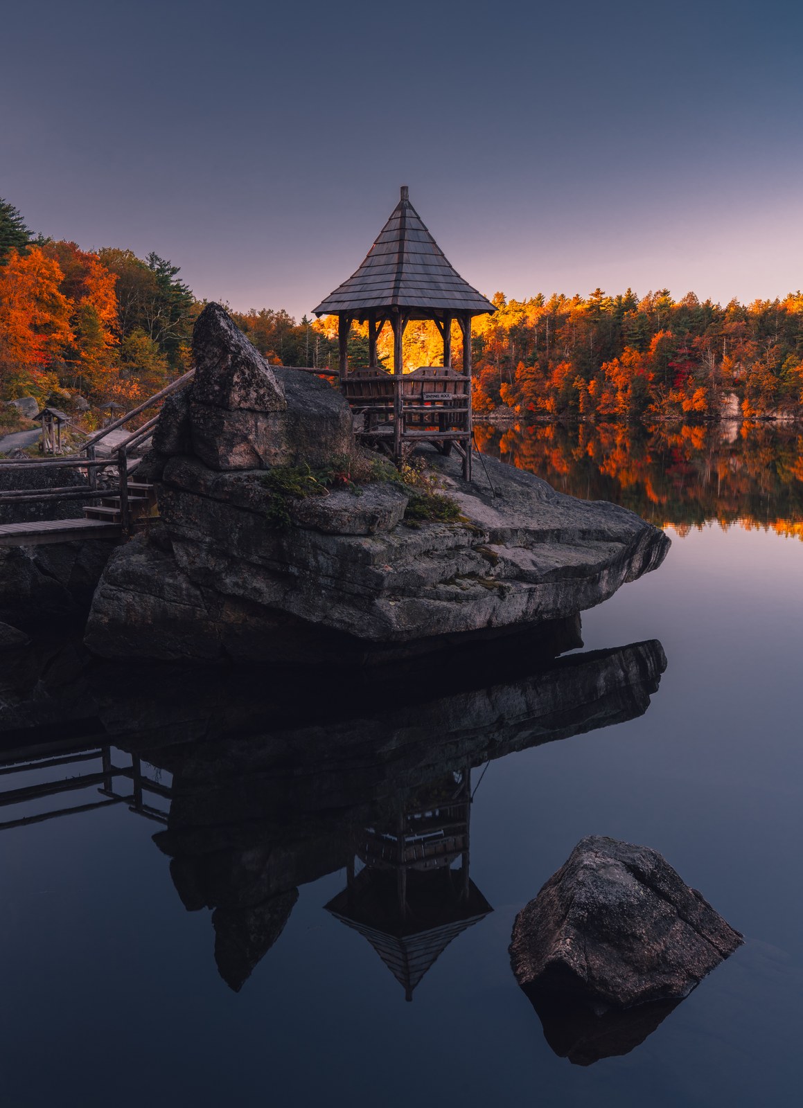 A lakeside pavilion at twilight.